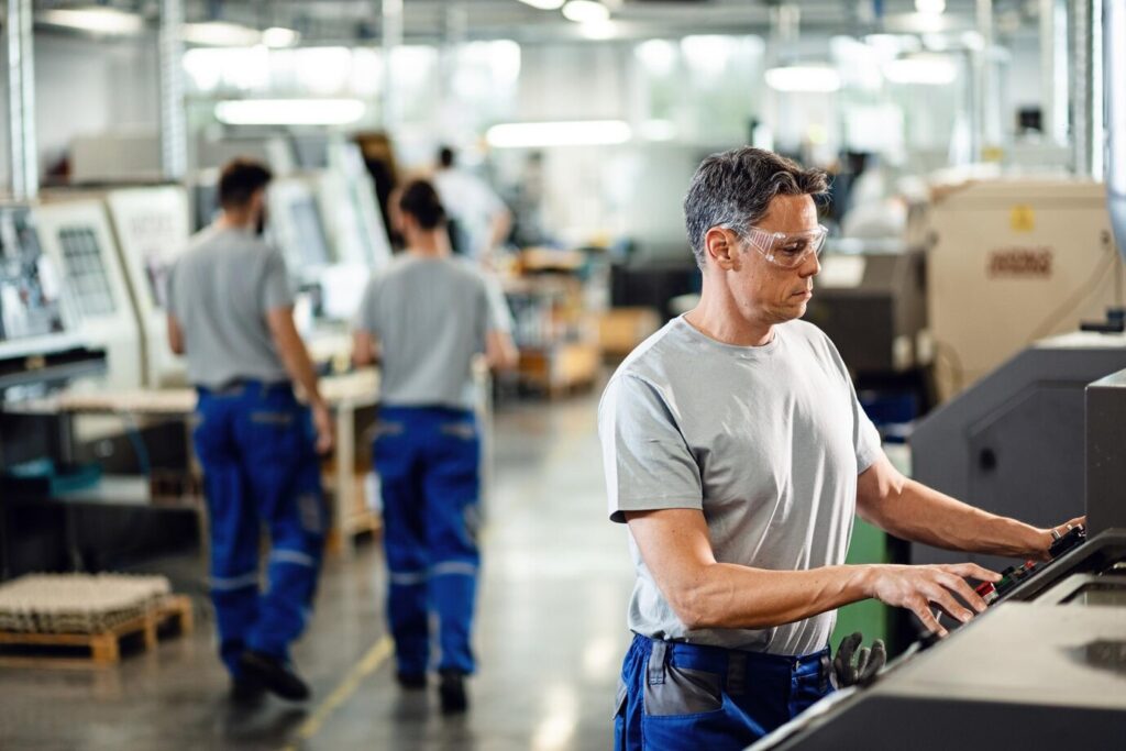 trabalhador adulto medio operando uma maquina cnc enquanto trabalhava em instalacoes industriais 637285 4166